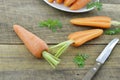 Tasty ripe carrots and double cut on wooden table, closeup Royalty Free Stock Photo