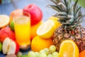 Tasty ripe fruits and a glass of juice on a wooden table Royalty Free Stock Photo