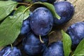 Tasty ripe plums and leaves on table, flat lay Royalty Free Stock Photo