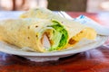 Tasty roll with chicken and vegetables on a plate