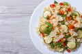 Tasty salad of farfalle pasta with vegetables closeup top view Royalty Free Stock Photo