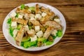 Tasty salad with fried chicken breast, green olives, feta cheese, avocado, lettuce and olive oil on wooden table Royalty Free Stock Photo