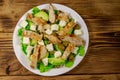 Tasty salad with fried chicken breast, green olives, feta cheese, avocado, lettuce and olive oil on wooden table. Top view Royalty Free Stock Photo