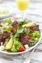 Tasty Salad with Grilled Beef Pieces, Cherry Tomatoes, feta Cheese and Kalamata Olives