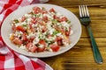 Tasty salad of tomato, cottage cheese, dill and olive oil on wooden table Royalty Free Stock Photo