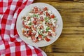 Tasty salad of tomato, cottage cheese, dill and olive oil on wooden table. Top view Royalty Free Stock Photo