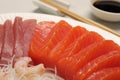 Tasty salmon slices, shrimp, funchosa and tuna on plate, closeup. Delicious sashimi dish