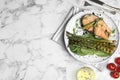 Tasty salmon steak served with grilled asparagus on white table, flat lay. Space for text Royalty Free Stock Photo