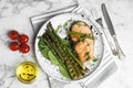 Tasty salmon steak served with grilled asparagus on marble table, flat lay Royalty Free Stock Photo