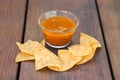 Tasty salsa sauce and Mexican nacho chips on wooden table, closeup Royalty Free Stock Photo