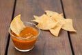 Tasty salsa sauce and Mexican nacho chips on wooden table, closeup Royalty Free Stock Photo