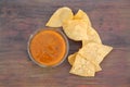 Tasty salsa sauce and Mexican nacho chips on wooden table, flat lay Royalty Free Stock Photo