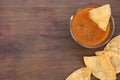 Tasty salsa sauce and Mexican nacho chips on wooden table, flat lay. Space for text Royalty Free Stock Photo