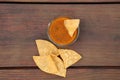 Tasty salsa sauce and Mexican nacho chips on wooden table, flat lay Royalty Free Stock Photo