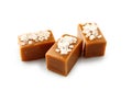 Tasty salty caramel candies on white background