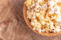 Tasty salty popcorn in wooden bowl on burlap napkin Royalty Free Stock Photo