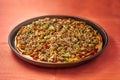 A tasty sardine pizza with olives, tomatoes and onions Royalty Free Stock Photo