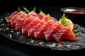 Tasty sashimi (pieces of fresh raw tuna) on black plate, closeup Royalty Free Stock Photo