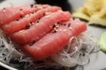 Tasty sashimi (pieces of fresh raw tuna) and glass noodles on plate, closeup