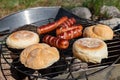 Tasty sausages prepared on the grill. A tasty meal outdoors in the home garden Royalty Free Stock Photo