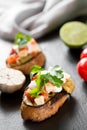 Tasty savory tomato Italian bruschetta, on slices of toasted baguette garnished with parsley Royalty Free Stock Photo