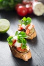 Tasty savory tomato Italian bruschetta, on slices of toasted baguette garnished with parsley Royalty Free Stock Photo