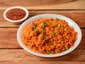 Tasty schezwan chicken fried rice with tomato sauce served in white bowl over a rustic wooden background, Indian cuisine, Royalty Free Stock Photo
