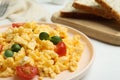 Tasty scrambled eggs with sprouts and cherry tomato on plate Royalty Free Stock Photo