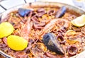 Tasty Seafood Paella in black pan -traditional spanish rice dish Royalty Free Stock Photo