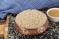 Tasty sesame paste and seeds. Closeup of lots of white sesame seeds. Pile of white sesame seeds