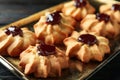 Tasty shortbread cookies with jam on table, closeup