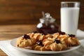 Tasty shortbread cookies with jam on table