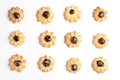 Tasty shortbread cookies with jam on white background