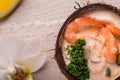 Tasty Shrimp soup with coconut milk, kaffir lime leaves, galangal, chilli and lemon grass in a coconut Royalty Free Stock Photo