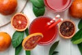 Tasty sicilian orange juice and fruits on white wooden table, flat lay Royalty Free Stock Photo