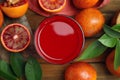 Tasty sicilian orange juice in glass and fruits on wooden table, flat lay Royalty Free Stock Photo