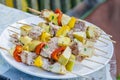 Tasty skewers of fresh fish with vegetables and apples on a wooden shish kebab Royalty Free Stock Photo