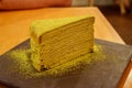 Tasty slice of honey Mille Crepe (thousand crepes) with custard powder sprinkled on