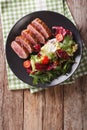 Tasty sliced roast duck breast with fresh vegetable salad close-up. vertical top view Royalty Free Stock Photo