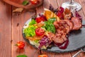 Tasty sliced roast duck breast with fresh vegetable salad closeup on a plate. Royalty Free Stock Photo