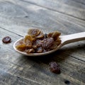 Tasty small black raisins on a wooden spoon Royalty Free Stock Photo