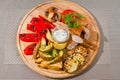 Tasty smoked sausages with grilled tomatoes, paprika, mushrooms, zucchini, fried potatoes, dill, white sour sauce Royalty Free Stock Photo