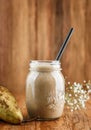 Tasty smoothie with pear and banana in glass on wooden background. Summer cold drink and healthy breakfast. Royalty Free Stock Photo