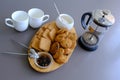 A tasty snack two cups of black tea and a plate of oatmeal cookies a wooden board on the gray background, leaf tea. Royalty Free Stock Photo