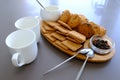 A tasty snack two cups of black tea and a plate of oatmeal cookies a wooden board on the gray background, leaf tea. Royalty Free Stock Photo