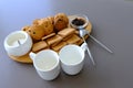 A tasty snack two cups of black tea and a plate of oatmeal cookies a wooden board on the gray background, leaf tea. Royalty Free Stock Photo