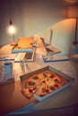 Tasty snacks to see you through the night. Still life shot of pizza on a desk in an office. Royalty Free Stock Photo