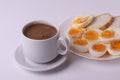 Esspresso coffee and soft boiled egg halves on the white plate and bread slices Royalty Free Stock Photo