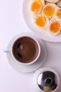 Esspresso coffee and soft boiled egg halves on the white plate and bread slices Royalty Free Stock Photo