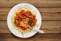 Tasty spaghetti with meatballs in tomato sause on wooden table o